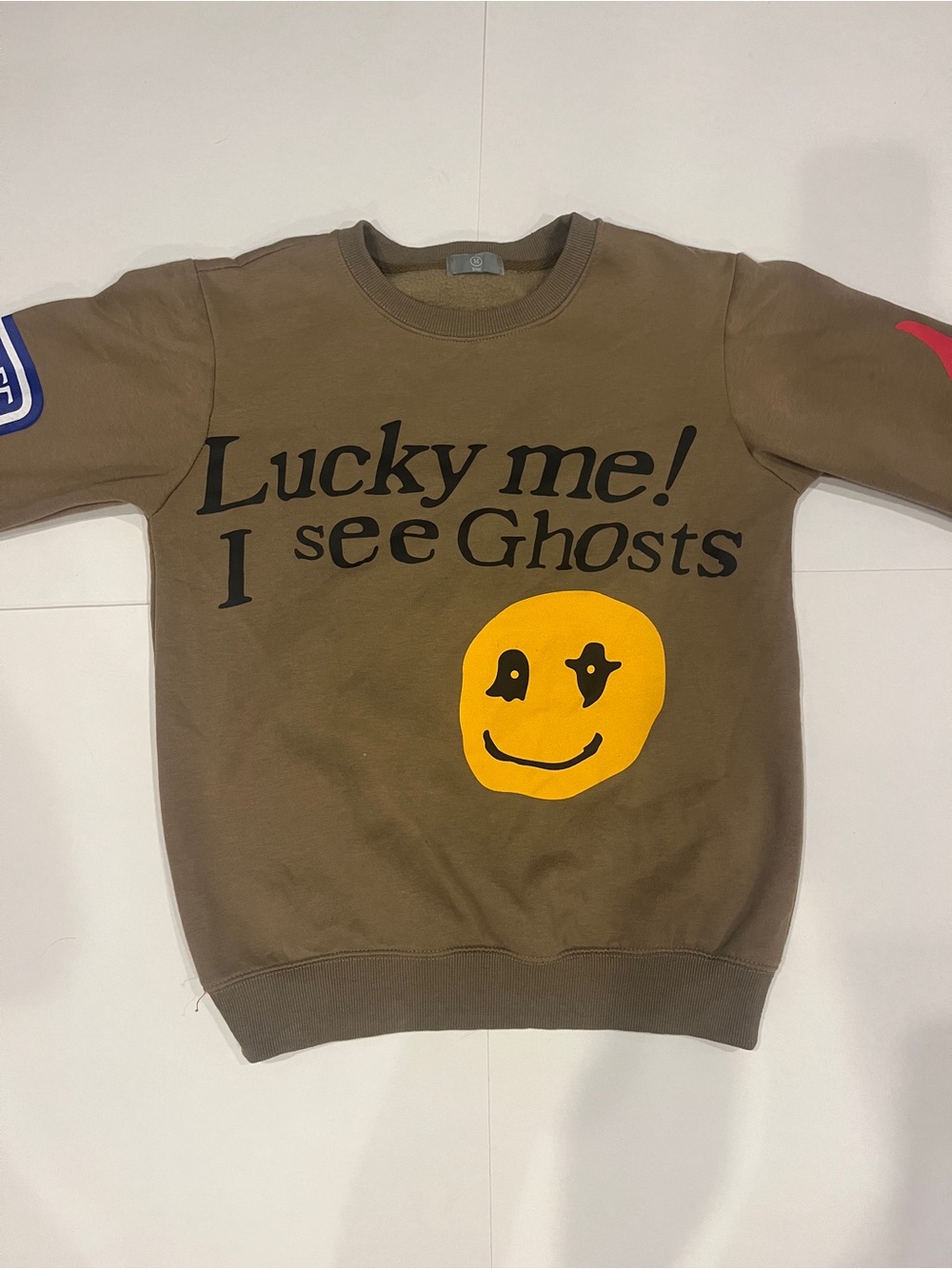 Cactus Plant Flea Market Brown Crewneck Sweatshirt with Yellow Smiley Graphic